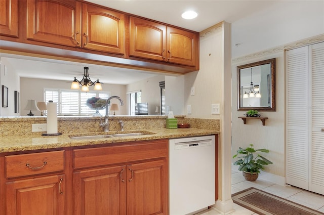 2595 Countryside Blvd Unit 8205, Clearwater, FL 33761 - kitchen featuring a sink, light stone counters, brown cabinets, and dishwasher
