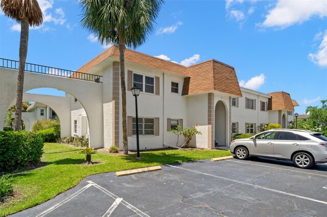 381 S Mcmullen Booth Rd Unit 72, Clearwater, FL 33759 - view of building exterior featuring uncovered parking