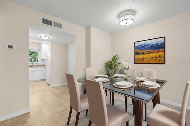 381 S Mcmullen Booth Rd Unit 72, Clearwater, FL 33759 - dining room featuring a textured ceiling, baseboards, visible vents, and light tile patterned floors