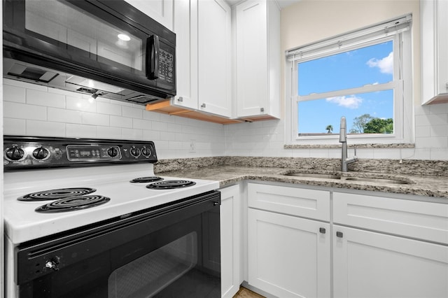 381 S Mcmullen Booth Rd Unit 72, Clearwater, FL 33759 - kitchen featuring white cabinets, electric range, black microwave, and a sink