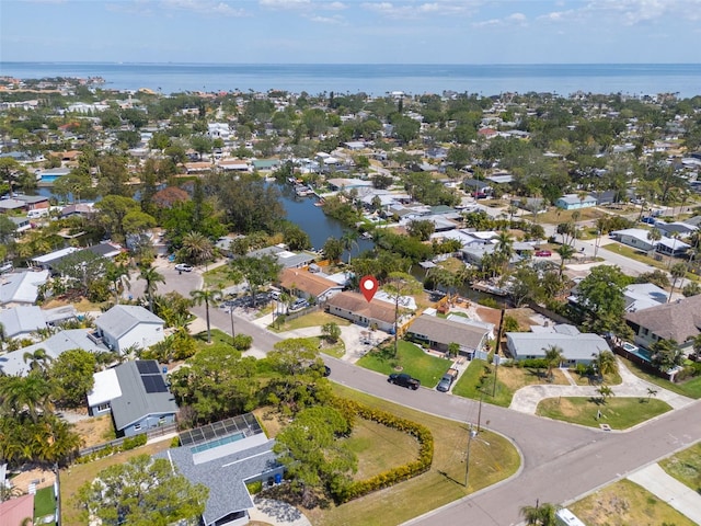 birds eye view of property with a water view and a residential view