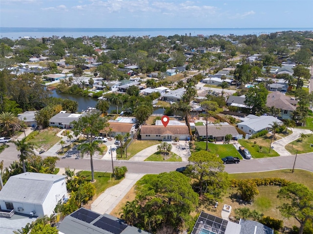 drone / aerial view featuring a water view and a residential view
