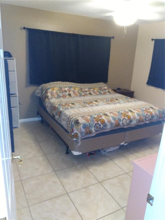 bedroom featuring baseboards and light tile patterned flooring