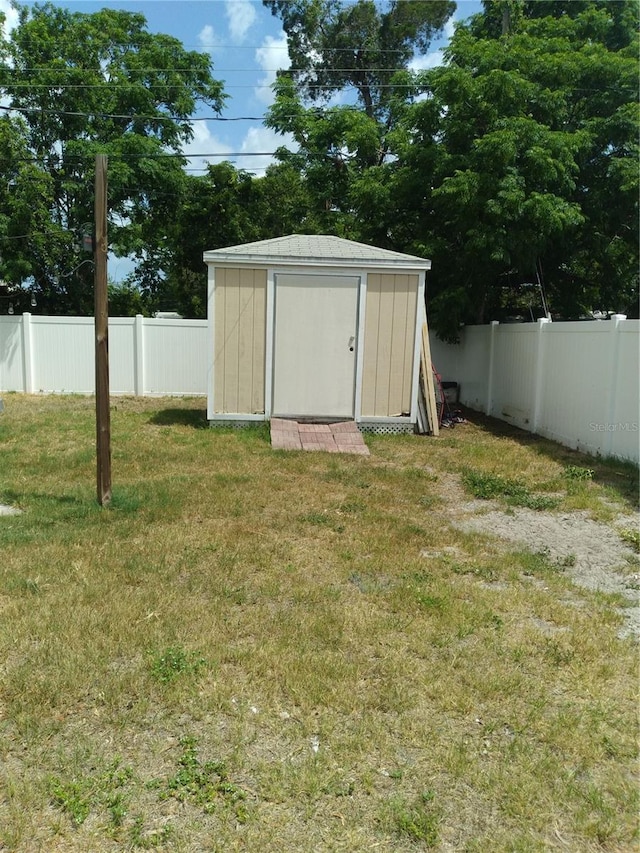 view of shed with a fenced backyard