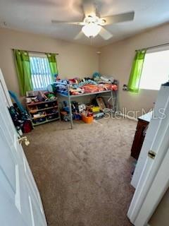 5443 Tangerine Dr, New Port Richey, FL 34652 - carpeted bedroom featuring ceiling fan