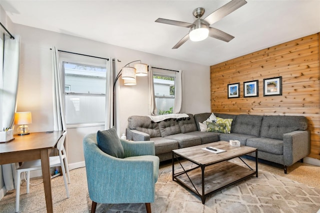 3626 17th St N, Saint Petersburg, FL 33713 - living room featuring ceiling fan, wood walls, baseboards, and light speckled floor