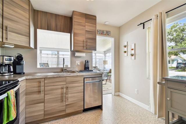 3626 17th St N, Saint Petersburg, FL 33713 - kitchen featuring baseboards, a sink, light speckled floor, light countertops, and appliances with stainless steel finishes