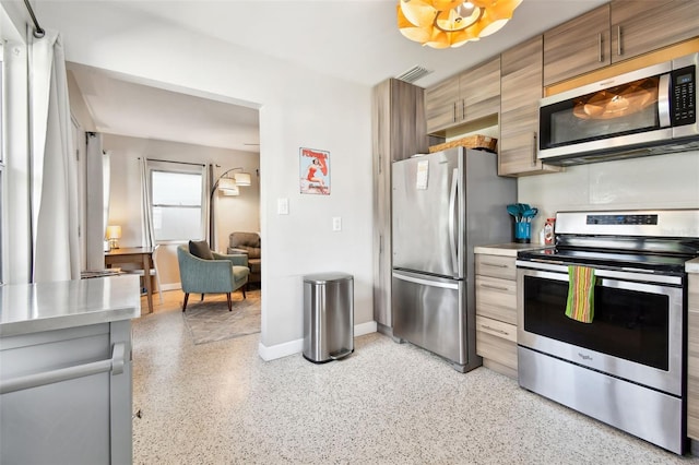 3626 17th St N, Saint Petersburg, FL 33713 - kitchen featuring stainless steel appliances, light speckled floor, visible vents, light countertops, and baseboards