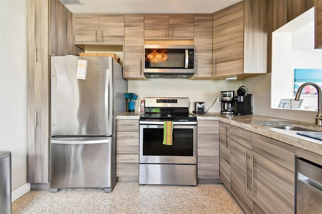 3626 17th St N, Saint Petersburg, FL 33713 - kitchen with a sink, stainless steel appliances, light countertops, and light speckled floor