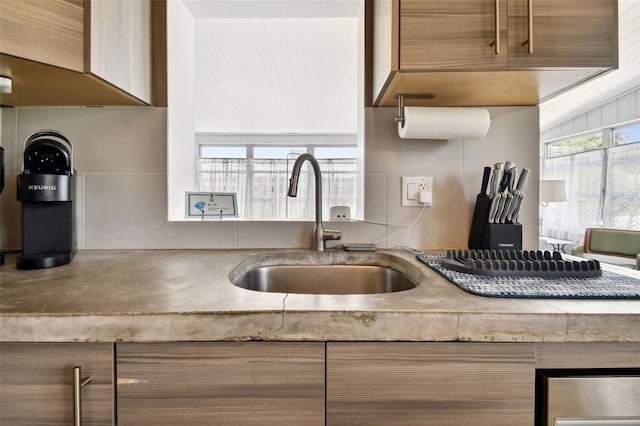 3626 17th St N, Saint Petersburg, FL 33713 - kitchen with brown cabinets, light countertops, decorative backsplash, and a sink