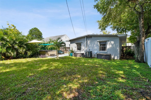 3626 17th St N, Saint Petersburg, FL 33713 - rear view of property with a fenced backyard, cooling unit, a hot tub, and a yard