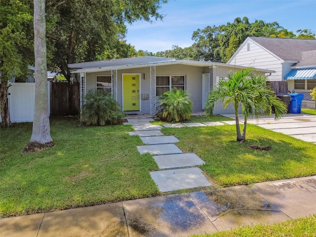 3626 17th St N, Saint Petersburg, FL 33713 - ranch-style house with driveway, stucco siding, a front lawn, and fence