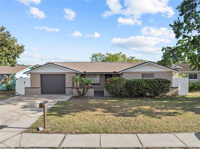 ranch-style house with driveway, a front yard, fence, an attached garage, and stucco siding