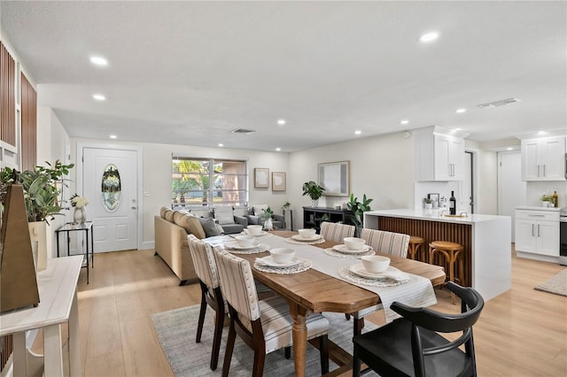 dining room with visible vents, recessed lighting, and light wood finished floors
