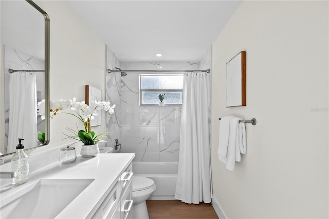 bathroom featuring toilet, shower / bathtub combination with curtain, and vanity