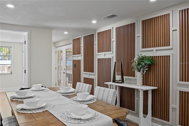 dining area with french doors, recessed lighting, a textured ceiling, and visible vents