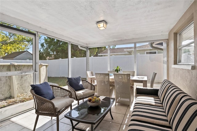 sunroom / solarium featuring outdoor dining space