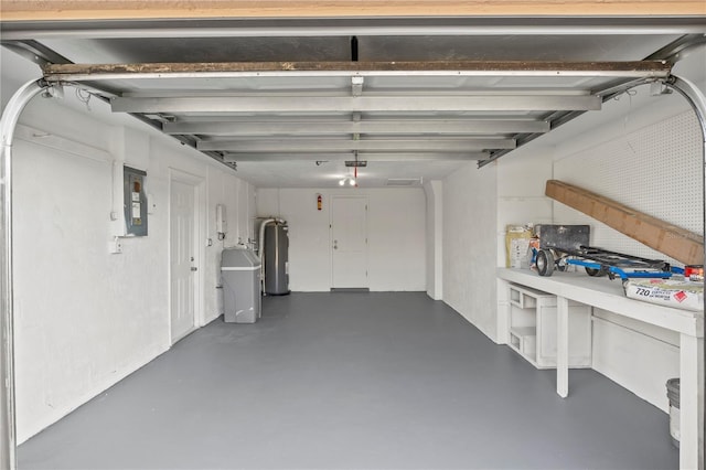 garage with a garage door opener, electric panel, and gas water heater