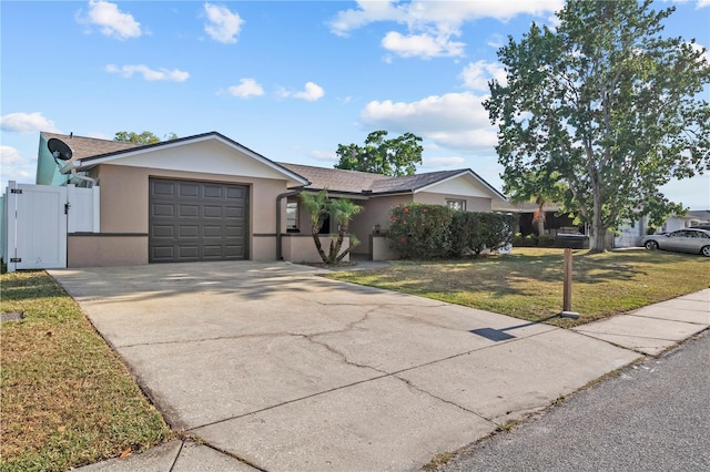 ranch-style house with a garage, a front lawn, stucco siding, a gate, and driveway