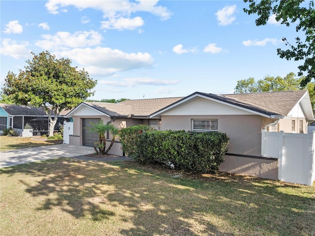 ranch-style house with fence, a front lawn, concrete driveway, an attached garage, and stucco siding