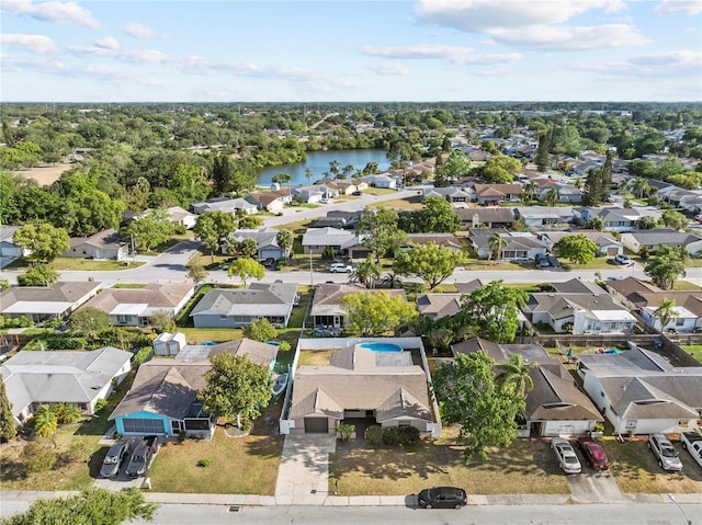 drone / aerial view with a water view and a residential view
