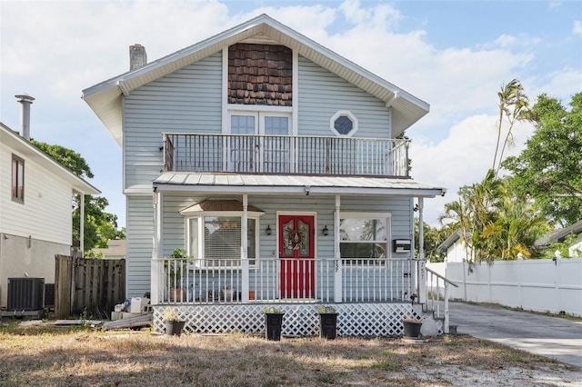 757 32nd Ave N, Saint Petersburg, FL 33704 - view of front facade with a porch, fence, a chimney, and central air condition unit