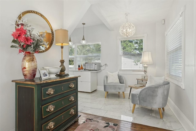 757 32nd Ave N, Saint Petersburg, FL 33704 - sitting room with baseboards, marble finish floor, and a notable chandelier