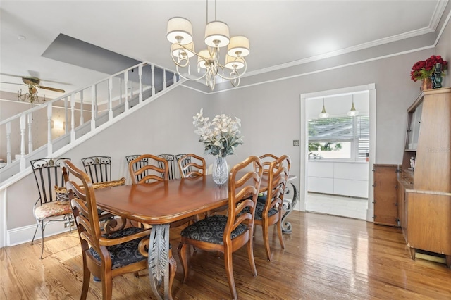 757 32nd Ave N, Saint Petersburg, FL 33704 - dining area featuring stairs, ornamental molding, wood finished floors, and ceiling fan with notable chandelier