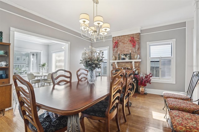 757 32nd Ave N, Saint Petersburg, FL 33704 - dining area featuring an inviting chandelier, baseboards, ornamental molding, and light wood finished floors