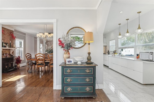 757 32nd Ave N, Saint Petersburg, FL 33704 - interior space with baseboards, ornamental molding, white microwave, and a notable chandelier