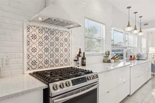 757 32nd Ave N, Saint Petersburg, FL 33704 - kitchen with tasteful backsplash, light stone countertops, stainless steel gas range, white cabinets, and custom range hood