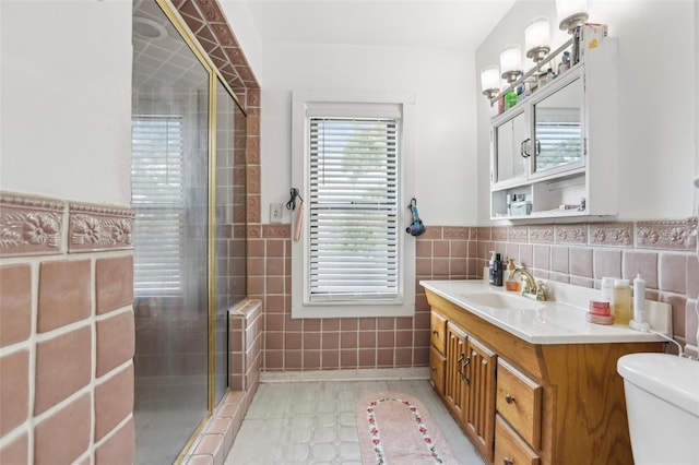 757 32nd Ave N, Saint Petersburg, FL 33704 - full bath featuring vanity, wainscoting, toilet, tile walls, and a stall shower