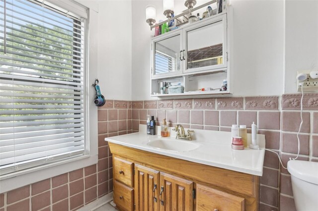 757 32nd Ave N, Saint Petersburg, FL 33704 - bathroom featuring toilet, tile walls, a wealth of natural light, and vanity