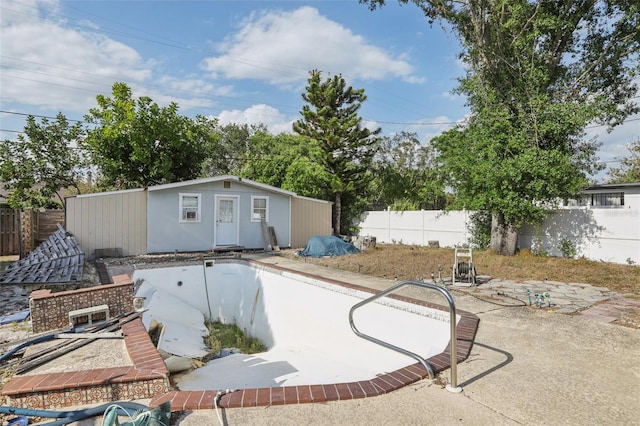 757 32nd Ave N, Saint Petersburg, FL 33704 - rear view of house with an outdoor structure, a fenced backyard, a patio area, and a fenced in pool