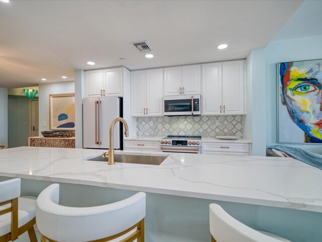 331 Cleveland St # 1806, Clearwater, FL 33755 - kitchen with visible vents, freestanding refrigerator, high end stainless steel range, white microwave, and a sink