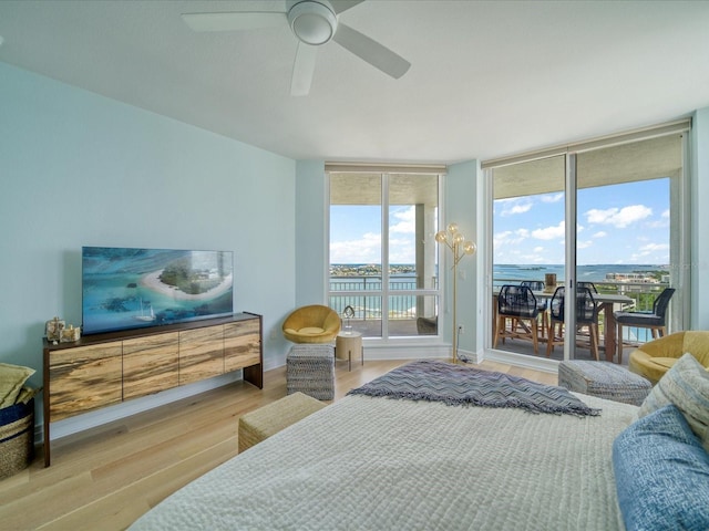 331 Cleveland St # 1806, Clearwater, FL 33755 - bedroom featuring access to outside, ceiling fan, wood finished floors, and expansive windows