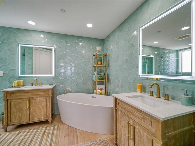 331 Cleveland St # 1806, Clearwater, FL 33755 - full bathroom featuring a sink, tile walls, wood finished floors, and visible vents