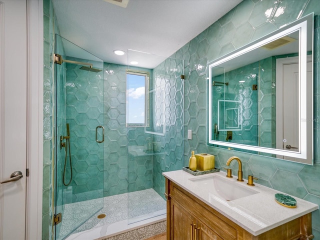 331 Cleveland St # 1806, Clearwater, FL 33755 - full bath featuring decorative backsplash, tile walls, a shower stall, and vanity