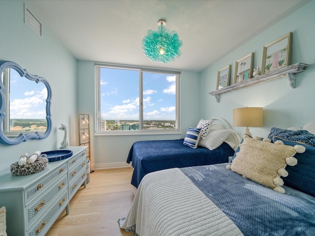 331 Cleveland St # 1806, Clearwater, FL 33755 - bedroom featuring baseboards, light wood-type flooring, and visible vents