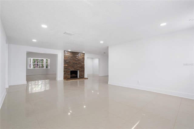 unfurnished living room featuring recessed lighting, baseboards, and tile patterned flooring