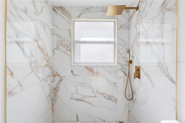 bathroom featuring a marble finish shower