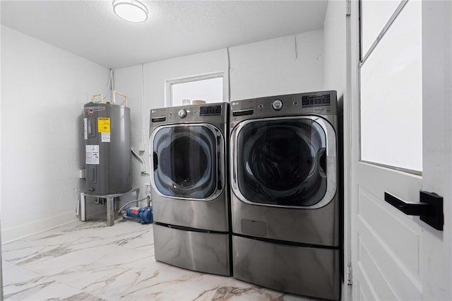 laundry area with laundry area, marble finish floor, washing machine and dryer, baseboards, and electric water heater