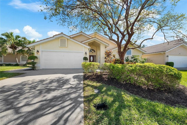5290 White Sand Cir NE, Saint Petersburg, FL 33703 - ranch-style house featuring stucco siding, an attached garage, and concrete driveway