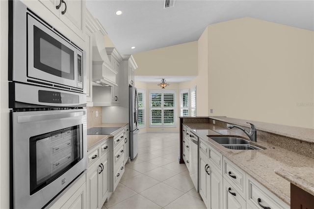5290 White Sand Cir NE, Saint Petersburg, FL 33703 - kitchen featuring a sink, stainless steel appliances, light stone counters, white cabinets, and light tile patterned floors