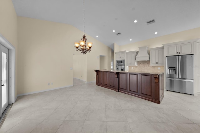 5290 White Sand Cir NE, Saint Petersburg, FL 33703 - kitchen featuring appliances with stainless steel finishes, premium range hood, a chandelier, tasteful backsplash, and light countertops