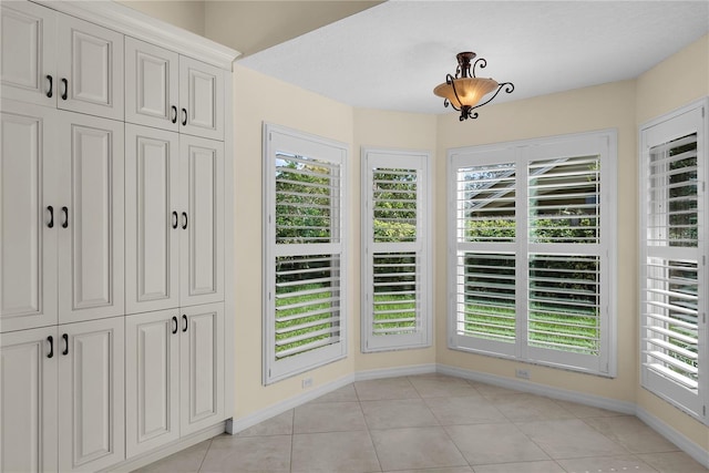5290 White Sand Cir NE, Saint Petersburg, FL 33703 - interior space with healthy amount of natural light, baseboards, and light tile patterned floors