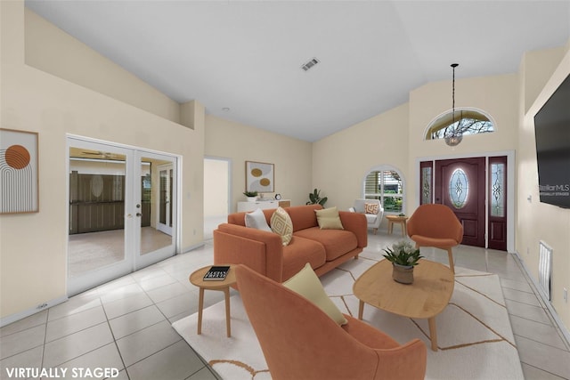 5290 White Sand Cir NE, Saint Petersburg, FL 33703 - living area with high vaulted ceiling, a chandelier, french doors, light tile patterned floors, and baseboards