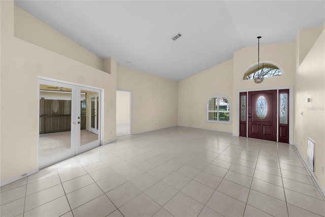 5290 White Sand Cir NE, Saint Petersburg, FL 33703 - entrance foyer featuring a chandelier, high vaulted ceiling, french doors, light tile patterned floors, and baseboards
