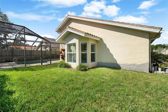 5290 White Sand Cir NE, Saint Petersburg, FL 33703 - back of house with stucco siding and glass enclosure