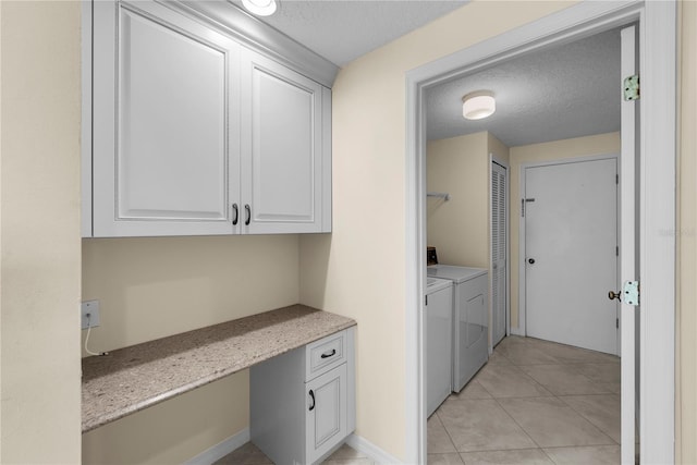 5290 White Sand Cir NE, Saint Petersburg, FL 33703 - washroom with washer and clothes dryer, a textured ceiling, light tile patterned floors, and a desk